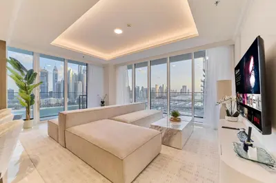 a living room with a couch and a large window at Luxury 3BR Marina View at Palace Beach Residence in Dubai