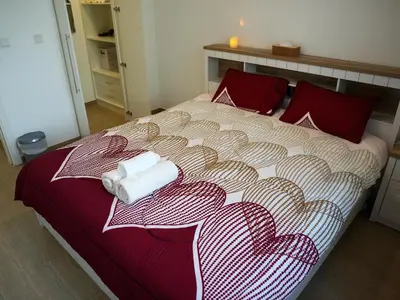 a bedroom with a bed with two towels on it at 2BR Next to Metro and EXPO City GYM Pool Playground in Dubai