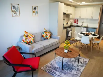 a living room with a couch and chairs and a table at 2BR Next to Metro and EXPO City GYM Pool Playground in Dubai