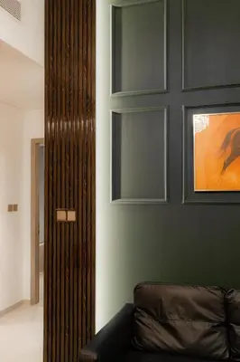 a living room with a couch and a green wall at Polo Bar DXB a High Floor 1BDR in Downtown Dubai in Dubai