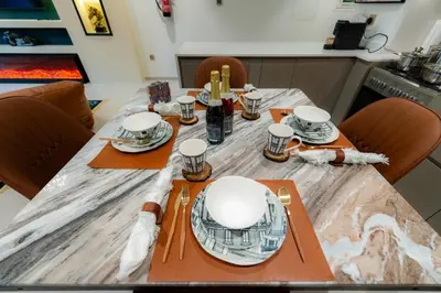 a table with orange napkins and plates on it at Polo Bar DXB a High Floor 1BDR in Downtown Dubai in Dubai