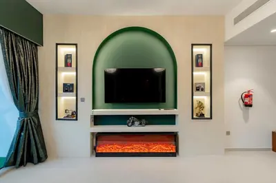 a living room with a tv and a fire place at Polo Bar DXB a High Floor 1BDR in Downtown Dubai in Dubai