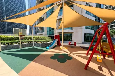 a playground with a slide and a swing at Silk Valley - Luxury 2BR in Downtown near Burj Khalifa & Dubai Mall in Dubai