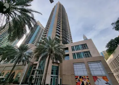 a tall building with palm trees in front of it at Silk Valley - Luxury 2BR in Downtown near Burj Khalifa & Dubai Mall in Dubai