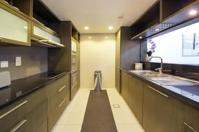 a kitchen with wooden cabinets and a sink at Silk Valley - Luxury 2BR in Downtown near Burj Khalifa & Dubai Mall in Dubai