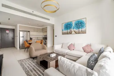 a living room with a couch and a table at New! Stunning 2BR wBalcony and Pool Marina Vista in Dubai