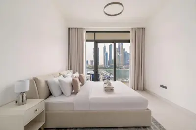 a living room with a couch and a large window at New! Stunning 2BR wBalcony and Pool Marina Vista in Dubai