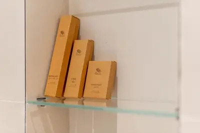 three boxes sitting on a glass shelf in a room at New! Stunning 2BR wBalcony and Pool Marina Vista in Dubai
