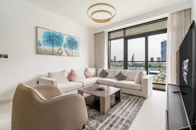 a living room with a couch and a tv at New! Stunning 2BR wBalcony and Pool Marina Vista in Dubai