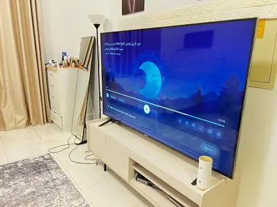 a large flat screen tv sitting on a stand at Studio in Dubai