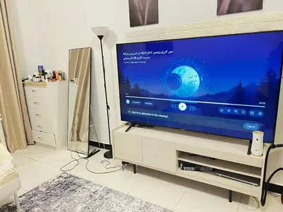 a flat screen tv sitting on a stand in a living room at Studio in Dubai