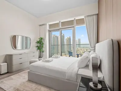 a bedroom with a large bed and a large window at Urban Compact 2BKH Sleeps 4 Full Burj Khalifa View in Dubai