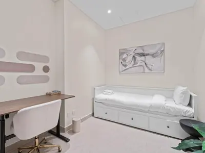 a white room with a bed and a desk at Urban Compact 2BKH Sleeps 4 Full Burj Khalifa View in Dubai