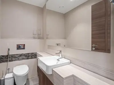 a white bathroom with a sink and a toilet at Urban Compact 2BKH Sleeps 4 Full Burj Khalifa View in Dubai