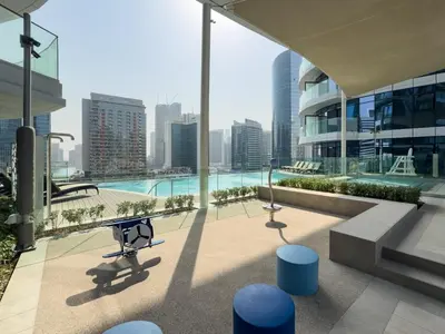 a view of a building with a pool and buildings at Urban Compact 2BKH Sleeps 4 Full Burj Khalifa View in Dubai