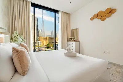 a bedroom with a large white bed and a large window at New! Spacious 2BR with Burj Views in Marquise Square in Dubai