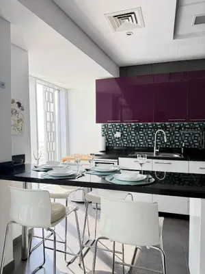 a kitchen with a dining table and white chairs at Cayan Tower, Dubai Marina in Dubai
