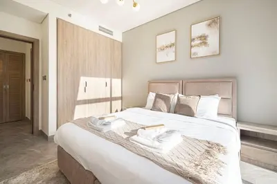 a bedroom with a large bed with two towels on it at Brand New Luxury Waterfront 2bd Beautiful Canal View in Dubai