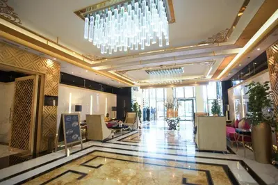 a lobby of a hotel with a chandelier at Damac Maison Mall Street! Upgraded 3 Bedroom with Burj and DIFC views! Nearest to Dubai Mall in Dubai