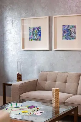 a living room with a couch and a table at Damac Maison Mall Street! Upgraded 3 Bedroom with Burj and DIFC views! Nearest to Dubai Mall in Dubai