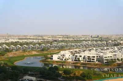 an aerial view of a city with buildings and a river at Luxury 1BR Apartment - DAMAC Hills - Infinity Pool in Dubai