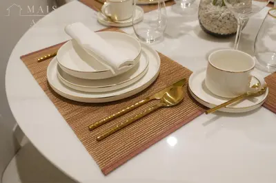 a table with plates and cups and spoons on a table at Luxury 1BR Apartment - DAMAC Hills - Infinity Pool in Dubai