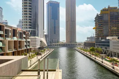 a river in the middle of a city with tall buildings at Luxury 3 Bedroom Apartment, 8 mins from Dubai Mall, Sleeps 6 people in Dubai
