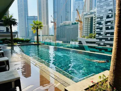 a swimming pool in a city with tall buildings at Sunrise Homes A Beautiful Studio in Downtown in Dubai