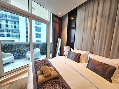 a bedroom with a large bed and a large window at Sunrise Homes A Beautiful Studio in Downtown in Dubai