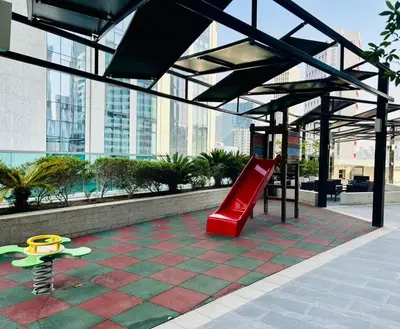 a playground in a building with a slide and a bench at Sunrise Homes A Beautiful Studio in Downtown in Dubai