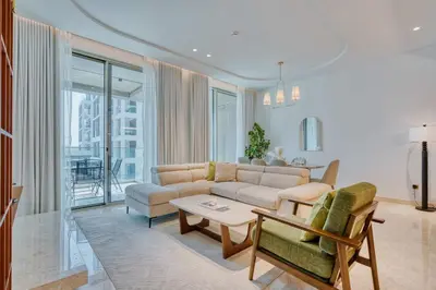 a living room with a couch and a table at PVH - Ellington Beach House - Luxurious 1BR with Private Beach Access in Dubai