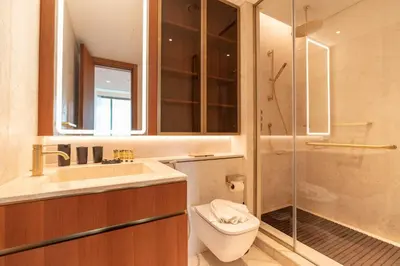 a bathroom with a toilet and a sink and a shower at PVH - Ellington Beach House - Luxurious 1BR with Private Beach Access in Dubai