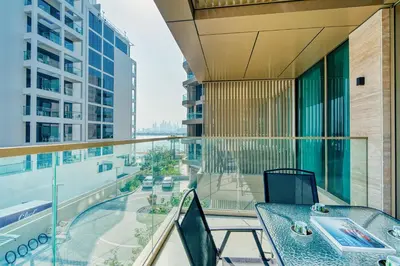 a balcony with a table and chairs on a building at PVH - Ellington Beach House - Luxurious 1BR with Private Beach Access in Dubai