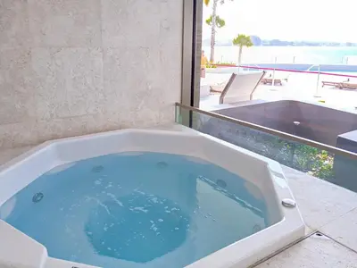 a jacuzzi tub with a view of a patio at PVH - Ellington Beach House - Luxurious 1BR with Private Beach Access in Dubai