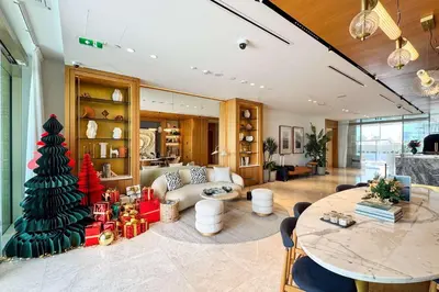 a living room with a christmas tree and a table at PVH - Ellington Beach House - Luxurious 1BR with Private Beach Access in Dubai