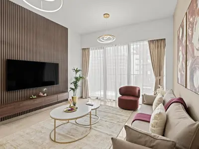 a living room with a couch and a tv at Grande Essence Elegant 1BR Sleeps 4 in Downtown in Dubai