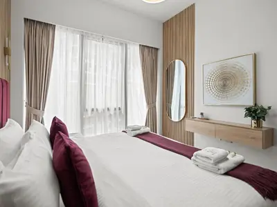a bedroom with a large bed with towels on it at Grande Essence Elegant 1BR Sleeps 4 in Downtown in Dubai