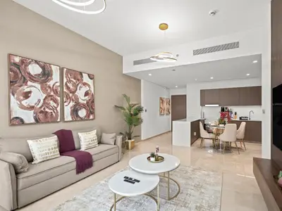 a living room with a couch and a table at Grande Essence Elegant 1BR Sleeps 4 in Downtown in Dubai