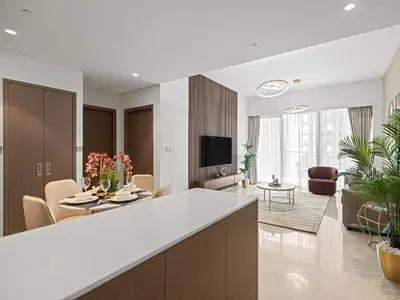 a kitchen and living room with a table and chairs at Grande Essence Elegant 1BR Sleeps 4 in Downtown in Dubai