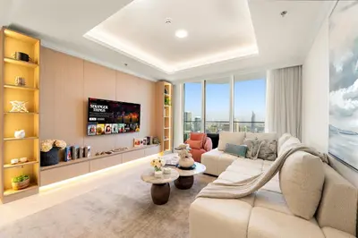 a living room with a couch and a tv at Luxe 2BR with Full Marina Views & Beach Access in Dubai