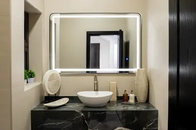 a bathroom with a sink and a large mirror at Iconic Villa in Dubai