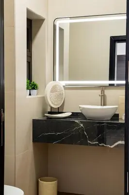 a bathroom with a sink and a mirror at Iconic Villa in Dubai