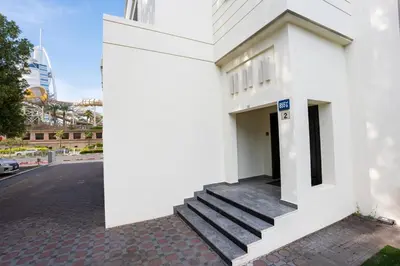 a white building with stairs on a street at Iconic Villa in Dubai