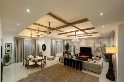 a living room with a couch and a table at Iconic Villa in Dubai