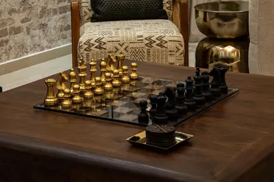a chess board on a wooden table with a chessboard at Iconic Villa in Dubai