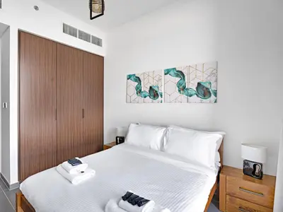 a bedroom with a bed with two towels on it at Creek Harbour Gem Stylish 2BR with Stunning Views-17 in Dubai