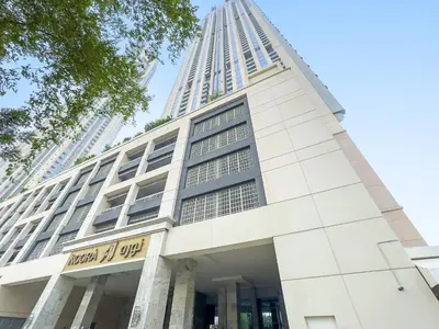 a building with a tall tower in the background at Charming City View w 1BDR Apartment In Noura Tower in Dubai