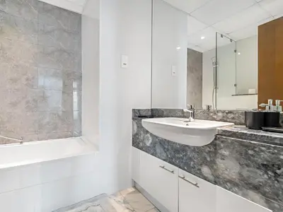 a bathroom with a sink and a bath tub and a sink at Charming City View w 1BDR Apartment In Noura Tower in Dubai