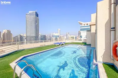 a large swimming pool on the roof of a building at bnbmehomes - Manchester Tower in Dubai