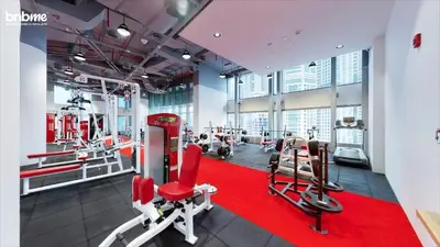 a gym with cardio equipment and a red carpet at bnbmehomes - Manchester Tower in Dubai